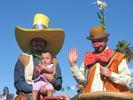 Stilt walkers with baby