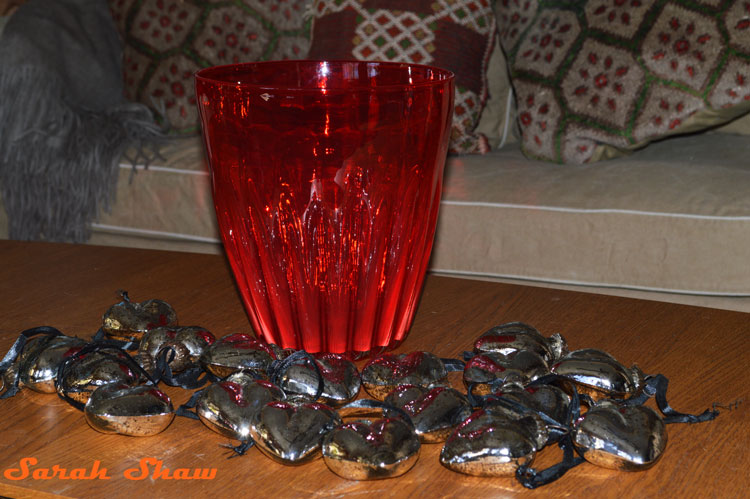 Red fluted glass vase with mercury glass hearts