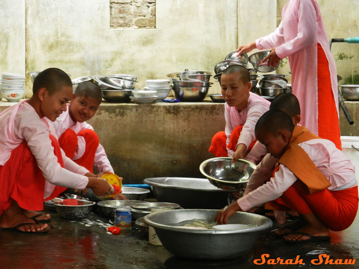 Buddhist nuns wash dishes after lunch at a nunnery outside of Mandalay, Myanmar