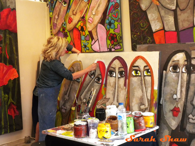 A woman paints at an art fair in Paris, France