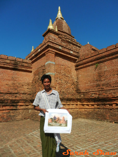 Buying a painting atop a temple in Bagan, Myanmar
