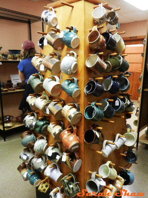 Tower of ceramic mugs at the Greater Lansing Potters Guild sale