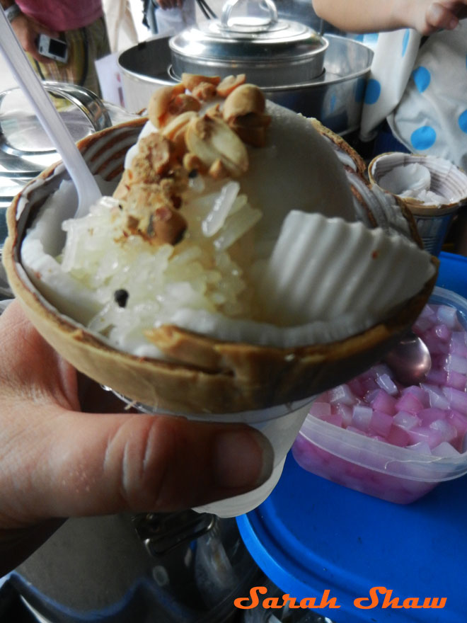 Fresh coconut ice cream makes a delicous break at Chatuchak Weekend Market, Bangkok, Thailand