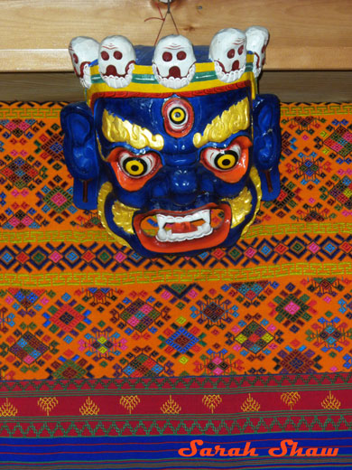 Woven fabric with mask in a Trashigang store in Bhutan