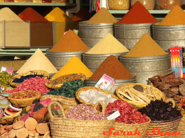 Colorful mounds of herbs and spices at a market in Marrakech, Morocco