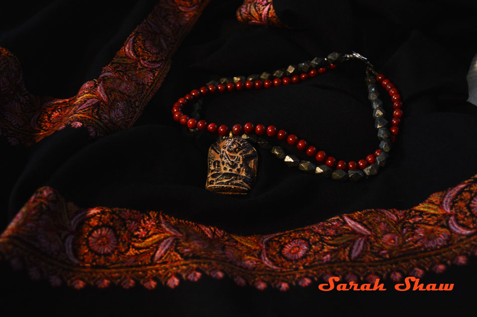 Amulet necklace on pashmina