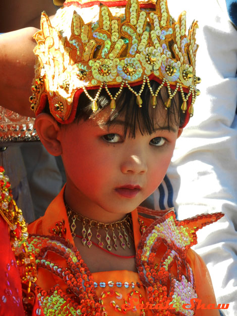 A young initiate outside a temple in Burma