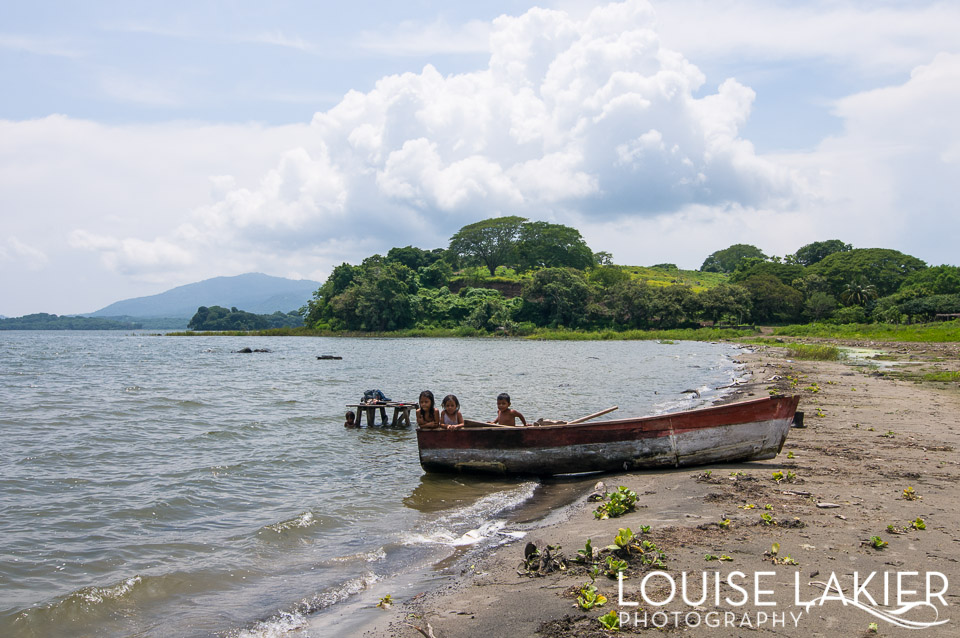 On the shores of Lake Nicaragua children play in a wooden boat