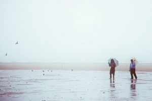Couple On Beach In Rain