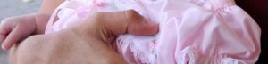 Holding baby in pink