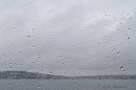 Raindrops on window to Puget Sound