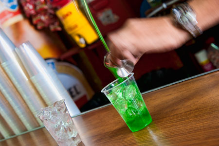 Pouring green rum horiz