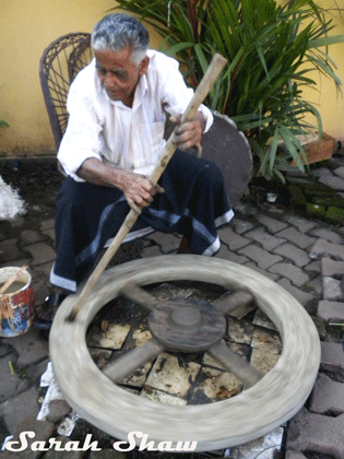 A potter spins a traditional potter's wheel in Kerala