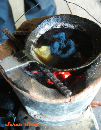 Preparing wax for Hmong batik in Laos
