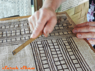 Adding pumpkin cucumber seeds in Hmong batik