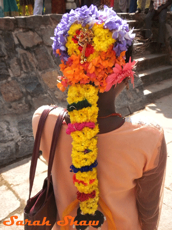 A girl's hair is flowered for Pongal