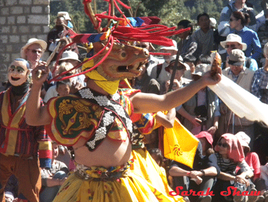 Bhutanese dancer whirls and spins during a festival dance