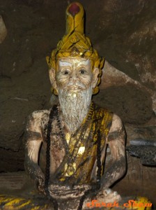 The statue of a  hermit wears prayer beads
