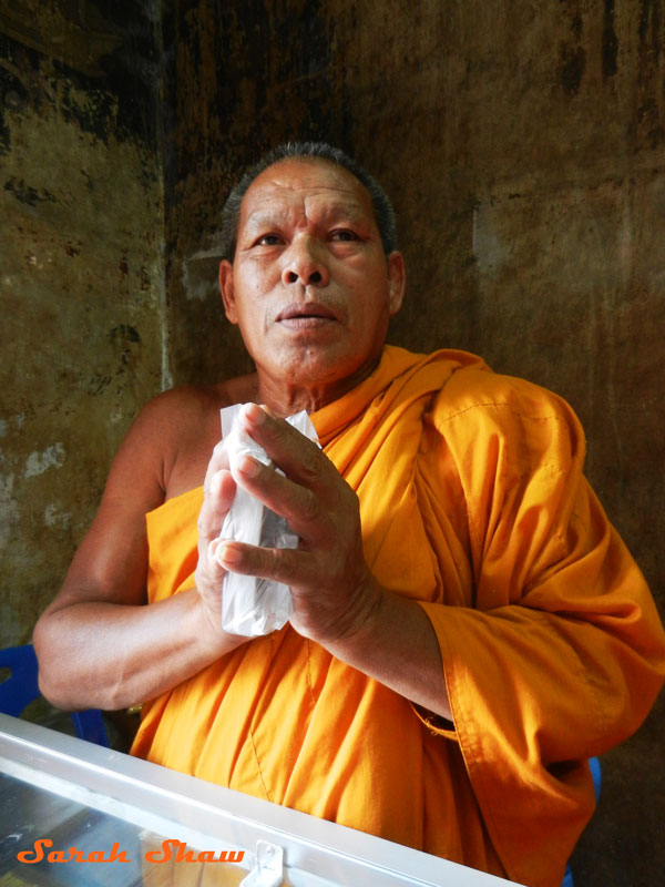 In Ayutthaya, a Buddhist monk blesses amulets with good luck