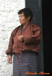 Bhutanese woman uses prayer beads