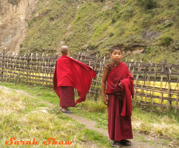 Adjusting the robes of a young monk in eastern Bhutan