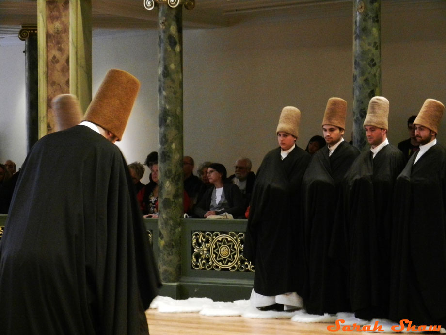 Dervishes greet each other before they begin whirling in Istanbul, Turkey