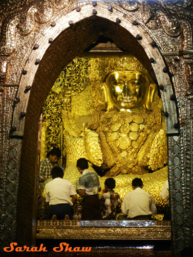 Offering Golf Leaf at a temple in Mandalay, Myanmar