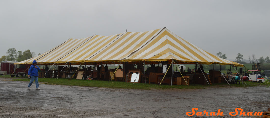 Tent full of furniture offered at an Amish Farm Auction