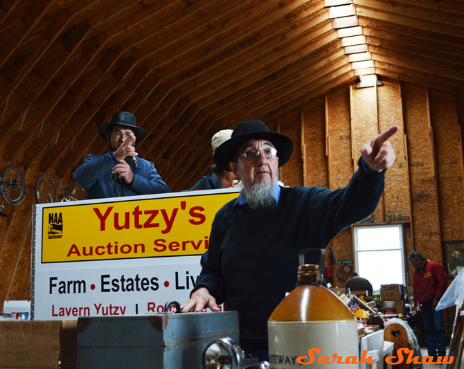 Bidders are recognized with a point at an Amish Farm Auction