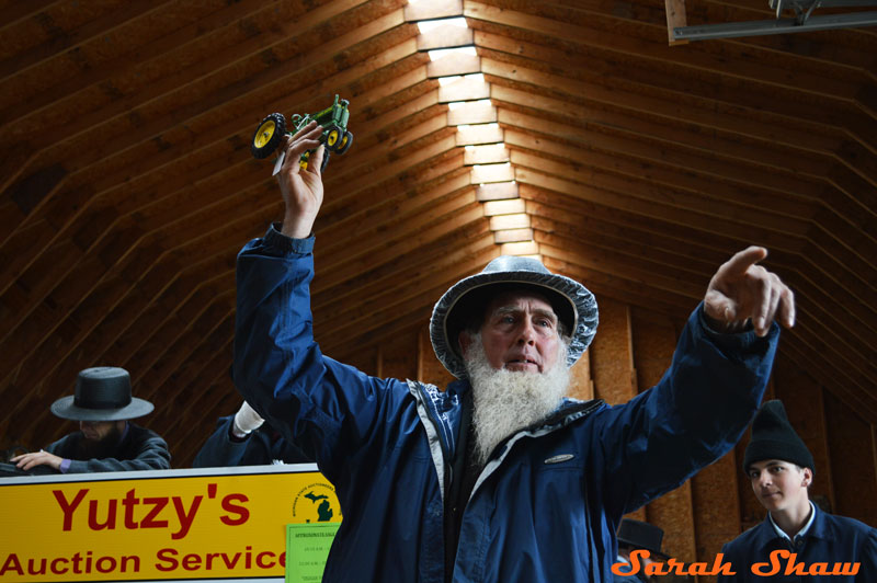 A toy tractor is sold at an Amish Farm Auction near Charlotte, Michigan