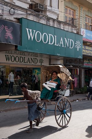 Woman Riding Rickshaw in India