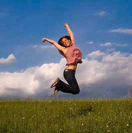 Woman Jumping in Field