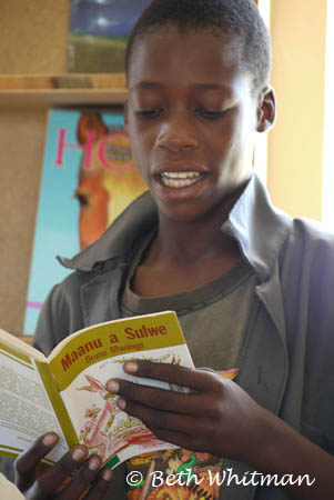 Boy Reading at library in Zambia