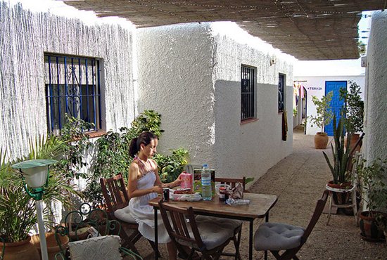 Woman Eating Breakfast At a Hostel