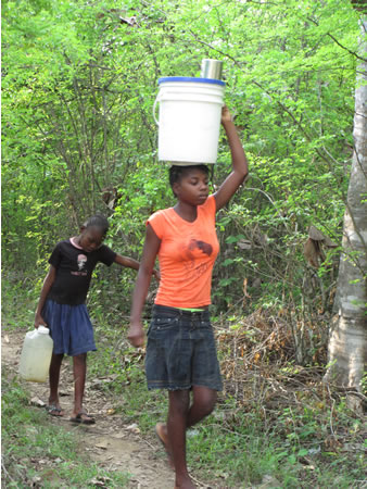 woman carrying water in Haiti