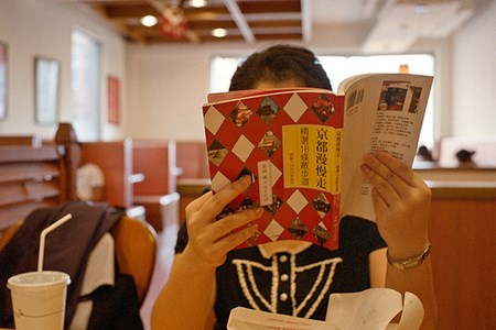 Woman Reading in Cafe