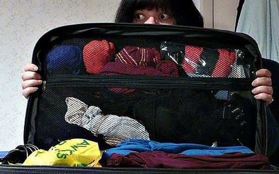 Woman with Packed Luggage